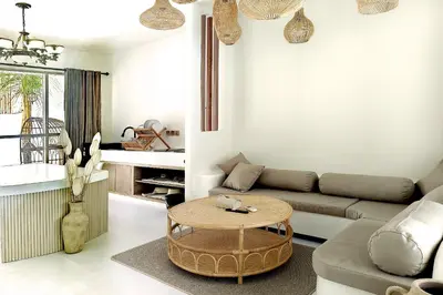a living room with a couch and a table at Sandwood Bejiayu in Seminyak