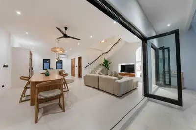 a living room with a table and a couch at Villa Aura - Spacious 1BR Private Pool Luxury Villa in Seminyak