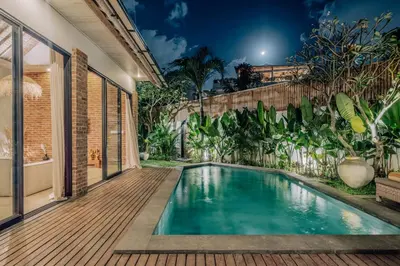 a swimming pool in the backyard of a house at Stylish 3BR Villa in Central Berawa Canggu - near Finns in Canggu