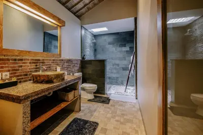 a bathroom with a sink and a toilet at Stylish 3BR Villa in Central Berawa Canggu - near Finns in Canggu