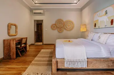 a bedroom with a large white bed and a desk at Stylish 3BR Villa in Central Berawa Canggu - near Finns in Canggu