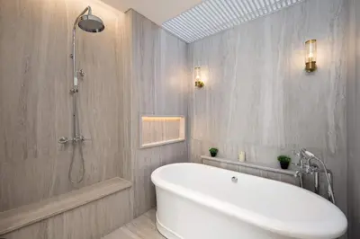 a bathroom with a white tub and a shower at Colonial House 4BR Villa Ocean View in Berawa in Canggu