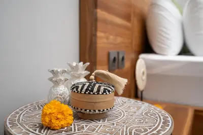 a table with a bowl and a brush and flowers on it at Villa Bella Poppy in Seminyak