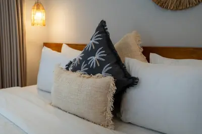 a pile of pillows sitting on top of a bed at Villa Bella Poppy in Seminyak