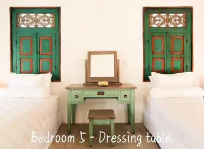 a bedroom with two beds and a table with a mirror at Villa Anh Yeu - 6 BR in Central Seminyak with Huge Pool & Garden in Seminyak