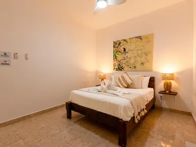 a bedroom with a bed with two lamps on it at Whitehouse Villa 2 Bedroom Seminyak in Seminyak