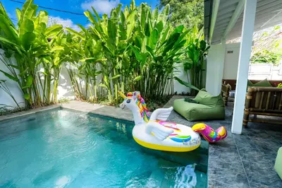 a pool with a unicorn float in a backyard at Whitehouse Villa 2 Bedroom Seminyak in Seminyak