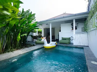 a swimming pool with a rubber duck and a inflatable pool toy at Whitehouse Villa 2 Bedroom Seminyak in Seminyak