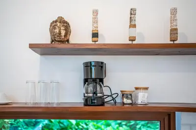 a coffee maker on a shelf with glasses at Villa Boha Seminyak in Seminyak