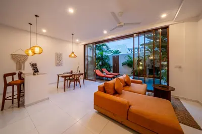 a living room with a couch and a table at Villa Boha Seminyak in Seminyak