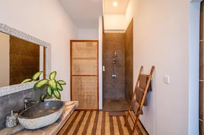 a bathroom with a sink and a shower at Villa Boha Seminyak in Seminyak