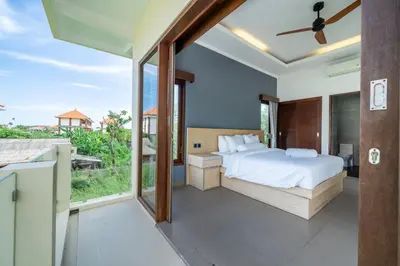 a bedroom with a bed and a large window at Villa Sunset-Near Seminyak Pool Free Airport Xfer in Seminyak