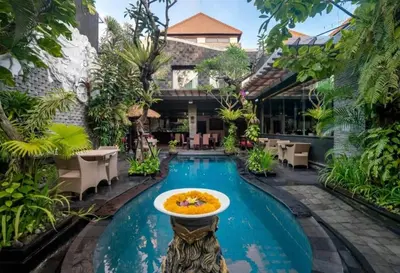 a pool at a resort with a bowl of food in it at Bougenville 4 BR Villa Seminyak CYN in Seminyak