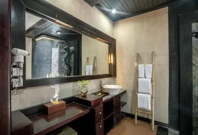 a bathroom with a sink and a mirror at Exquisite 3 BR Villa Seminyak CYN in Seminyak