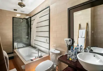 a bathroom with a tub and a sink and a toilet at Exquisite 3 BR Villa Seminyak CYN in Seminyak
