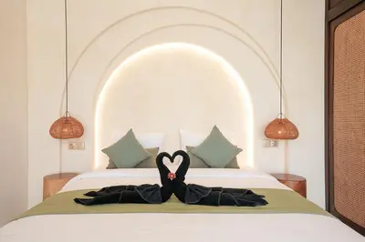 a bed with a heart shaped towel on it at Villa Arya 1 in Kerobokan