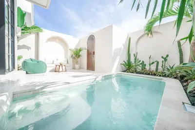 a swimming pool in a house with plants at Villa Arya 1 in Kerobokan