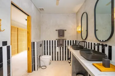 a bathroom with two sinks and a toilet at Villa Javel in Seminyak