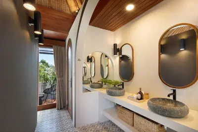two sinks in a bathroom with two mirrors at Gorgeous 6 beds, 14 pax in the heart of Seminyak in Seminyak
