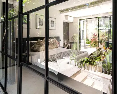 a bedroom with a bed in a window at Sophisticated Luxe Martini 1 - 1BR Villa in Kerobokan