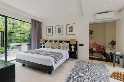 a bedroom with a bed and a living room at Sophisticated Luxe Martini 1 - 1BR Villa in Kerobokan