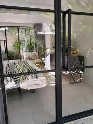 a view through a glass window of a patio at Sophisticated Luxe Martini 1 - 1BR Villa in Kerobokan