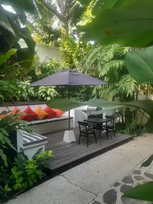 a patio with a table and chairs and an umbrella at Sophisticated Luxe Martini 1 - 1BR Villa in Kerobokan