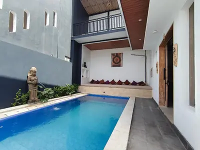 a swimming pool in the middle of a house at Casa Walter in Seminyak