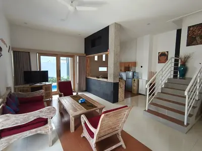 a living room with a couch and a table at Casa Walter in Seminyak