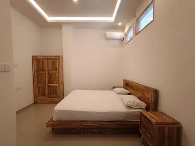 a small bedroom with a bed and a window at Casa Walter in Seminyak