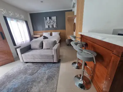 a living room with a couch and a chair at The Sania's in Seminyak