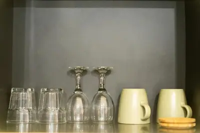 a group of glasses and cups sitting on a table at Forseti Athena Managed by ARM One Hundred in Seminyak