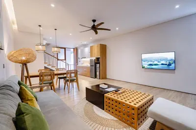 a living room with a couch and a table at Forseti Athena Managed by ARM One Hundred in Seminyak