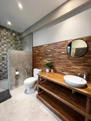 a bathroom with a sink and a toilet and a mirror at Cozy villa 777 near canggu 3BR in Kerobokan