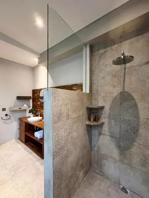 a bathroom with a glass shower with a sink at Cozy villa 777 near canggu 3BR in Kerobokan