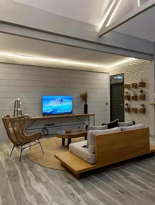 a living room with a couch and a tv at Cozy villa 777 near canggu 3BR in Kerobokan