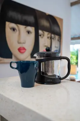 a tea kettle and a cup on a counter at Villa Yang Tao 4 in Seminyak