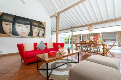 a living room with a red couch and a table at Villa Yang Tao 4 in Seminyak