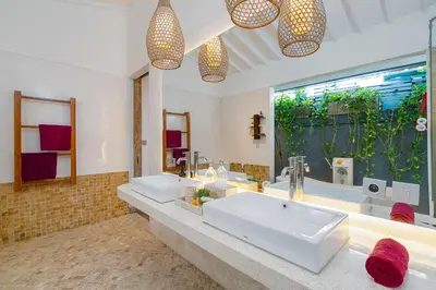 a bathroom with two sinks and a large window at Villa Yang Tao 4 in Seminyak