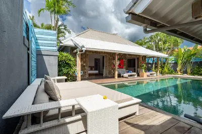 a villa with a swimming pool and a house at Villa Yang Tao 4 in Seminyak