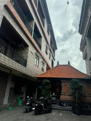 a motorcycle parked in front of a building at Brekele Berawa Beachhouse in Canggu