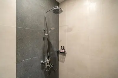 a shower with a glass door in a bathroom at Nyma 2BR Villa Seminyak in Seminyak