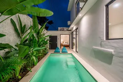 an indoor pool in a house with plants at Nyma 2BR Villa Seminyak in Seminyak
