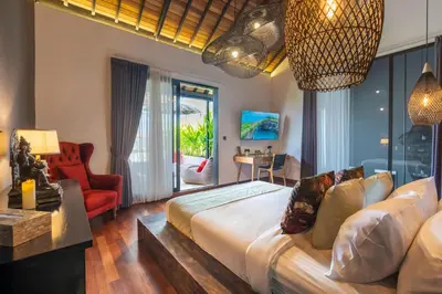 a bedroom with a large bed and a living room at Seminyak Villa 2 BR & private pool - Breakfast included in Seminyak