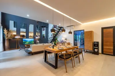 a dining room with a table and a couch at Seminyak Villa 2 BR & private pool - Breakfast included in Seminyak