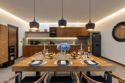 a dining room with a wooden table in a kitchen at Seminyak Villa 2 BR & private pool - Breakfast included in Seminyak
