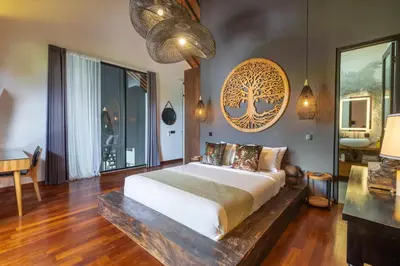 a bedroom with a large bed with a wooden floor at Seminyak Villa 2 BR & private pool - Breakfast included in Seminyak