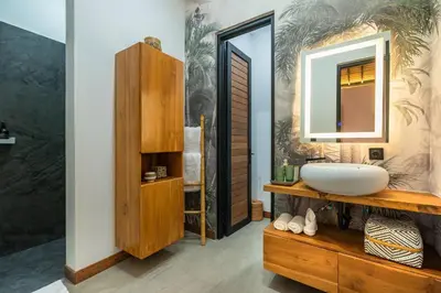 a bathroom with a sink and a mirror at Seminyak Villa 2 BR & private pool - Breakfast included in Seminyak