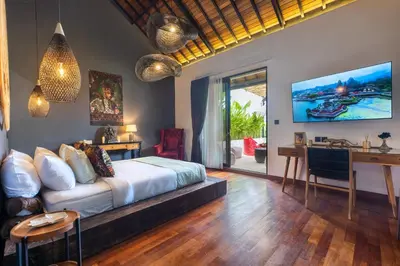 a bedroom with a bed and a desk and a table at Seminyak Villa 2 BR & private pool - Breakfast included in Seminyak