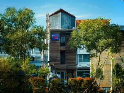 a building with a sign on the side of it at Kuta Cube Hostel in Kuta